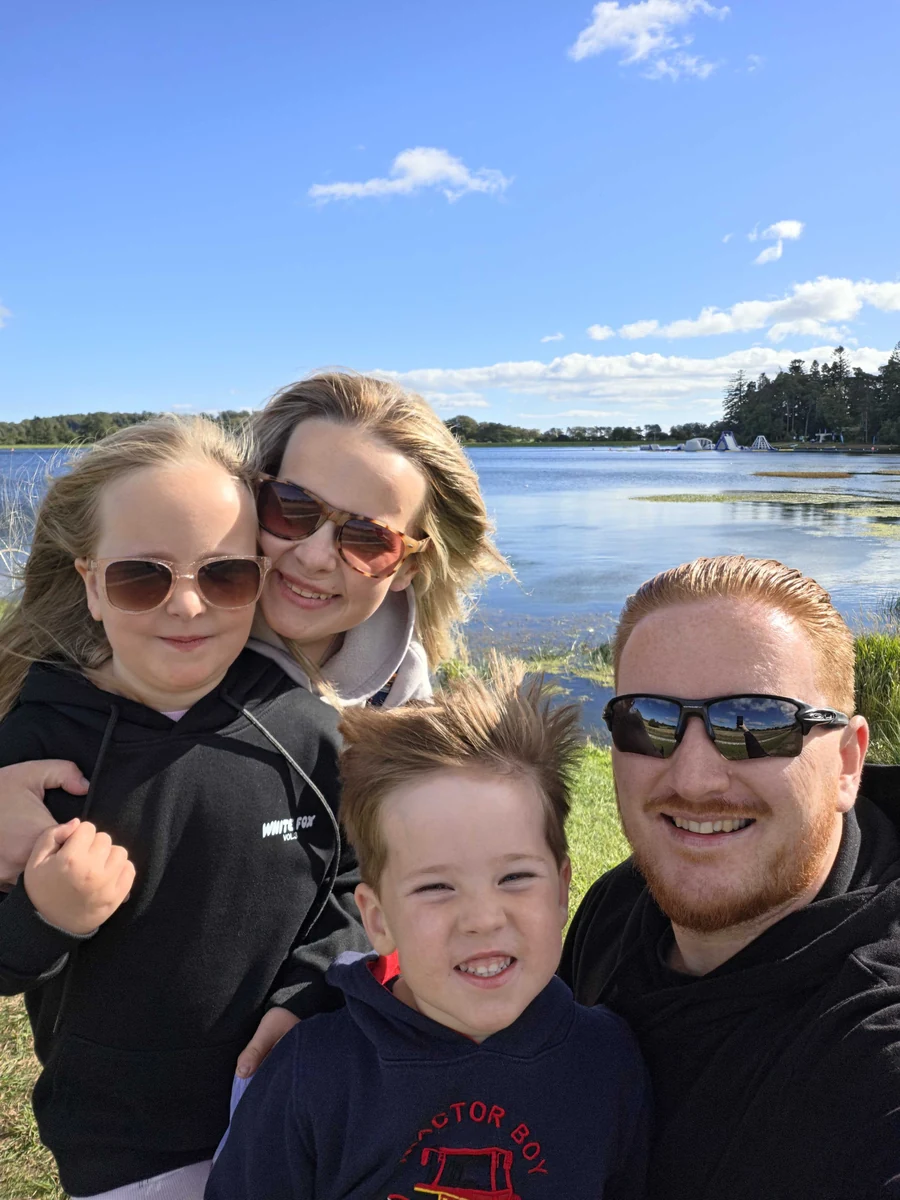 Stuart Martin and his family beside a lake